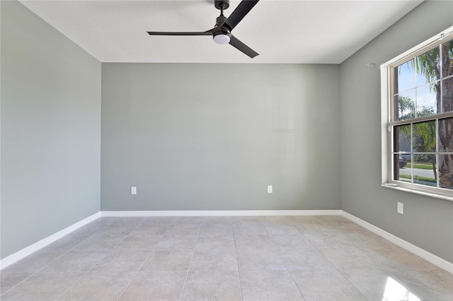 tiled empty room with ceiling fan and a textured ceiling