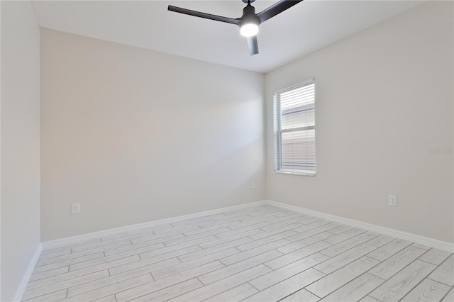 spare room featuring light wood-type flooring and ceiling fan