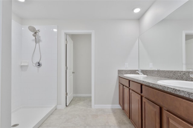 bathroom with vanity, tile patterned floors, and tiled shower