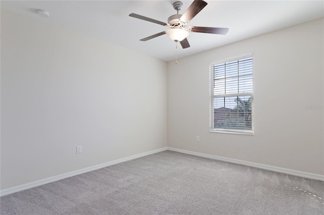 spare room with ceiling fan and light colored carpet