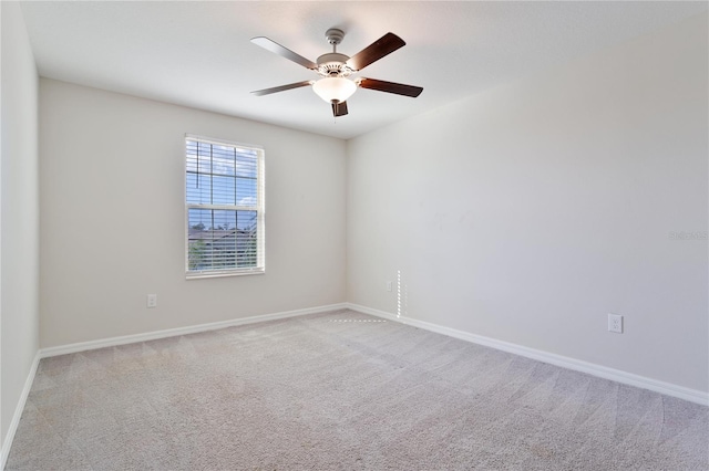 empty room featuring ceiling fan and light colored carpet