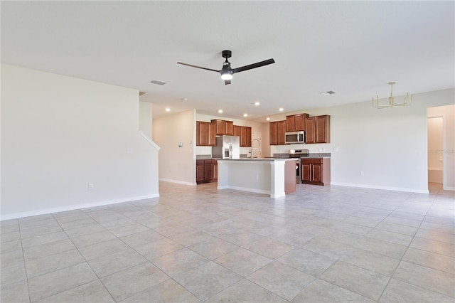 unfurnished living room featuring light tile patterned floors, ceiling fan with notable chandelier, and sink