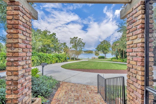 exterior space with a water view and a lawn