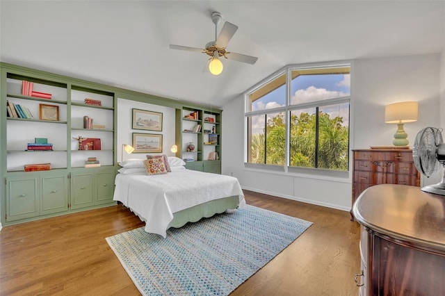 bedroom featuring light hardwood / wood-style floors, ceiling fan, and vaulted ceiling