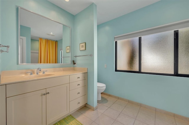 bathroom with vanity, tile patterned flooring, and toilet