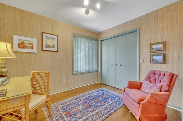 sitting room with hardwood / wood-style flooring