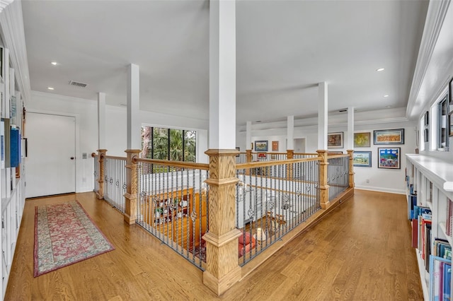 hall featuring ornamental molding and hardwood / wood-style flooring