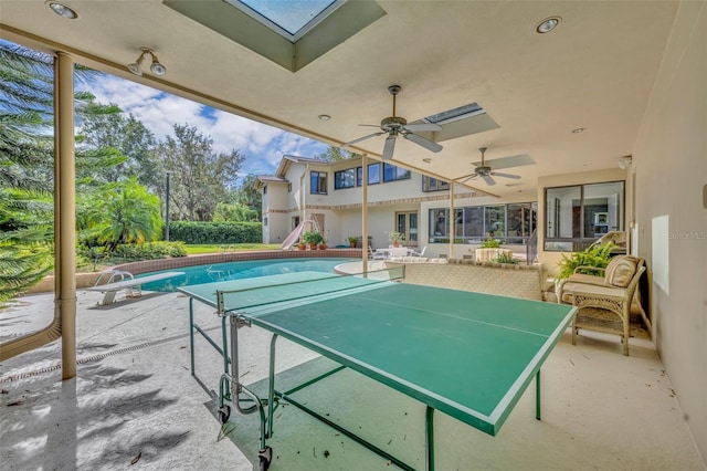 exterior space with ceiling fan and a patio area