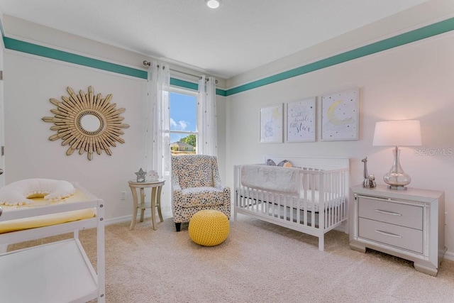 bedroom with light carpet and a crib