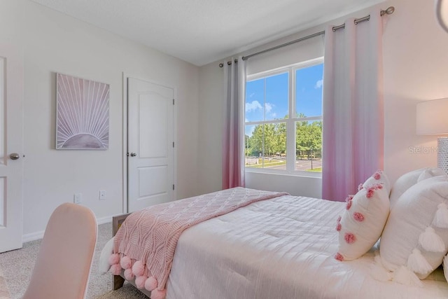 carpeted bedroom featuring multiple windows