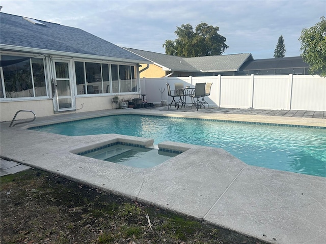 view of pool with an in ground hot tub and a patio