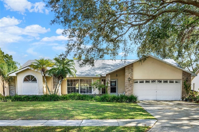 single story home with a garage and a front lawn