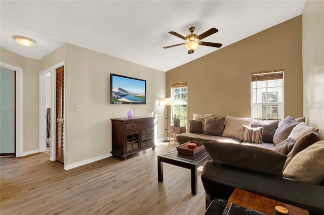 living room with light hardwood / wood-style flooring, ceiling fan, and lofted ceiling