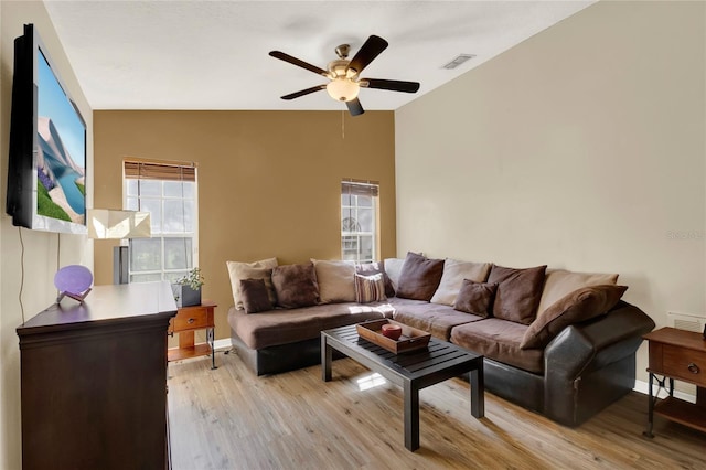 living room featuring light hardwood / wood-style floors and ceiling fan