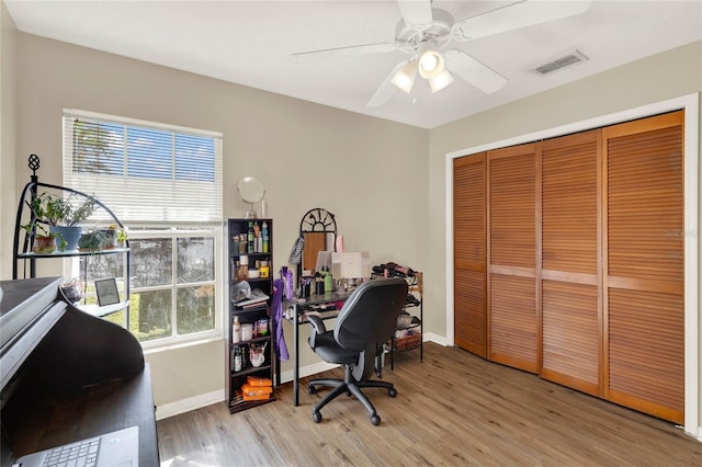 office area with light hardwood / wood-style flooring, plenty of natural light, and ceiling fan