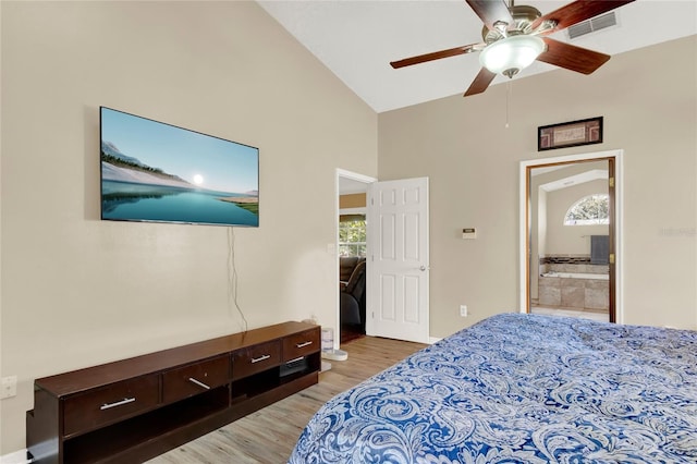 bedroom with connected bathroom, light hardwood / wood-style flooring, ceiling fan, and lofted ceiling