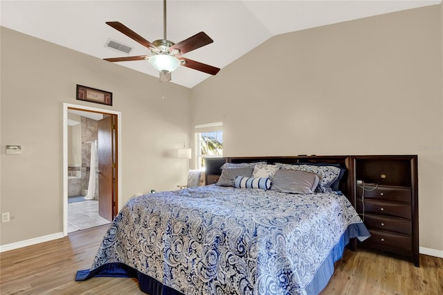 bedroom featuring connected bathroom, ceiling fan, light hardwood / wood-style floors, and lofted ceiling