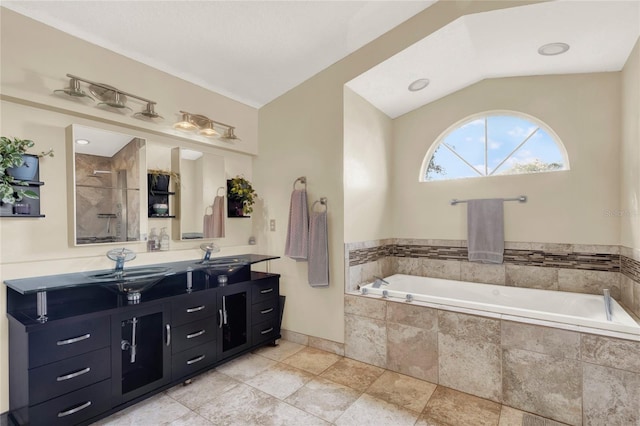 bathroom featuring vanity, lofted ceiling, and independent shower and bath