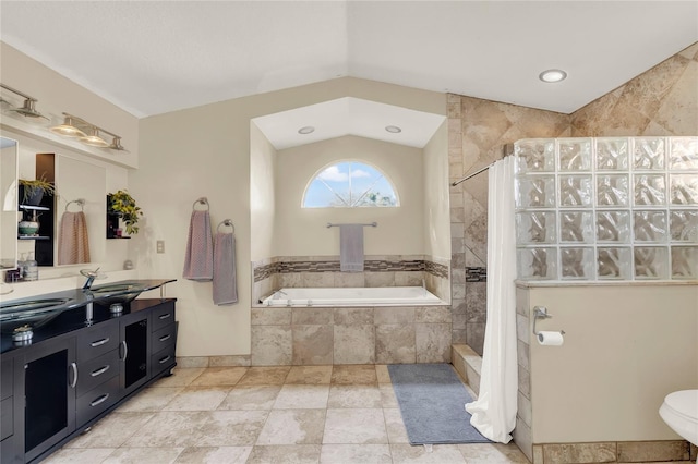 bathroom with shower with separate bathtub, vanity, and vaulted ceiling