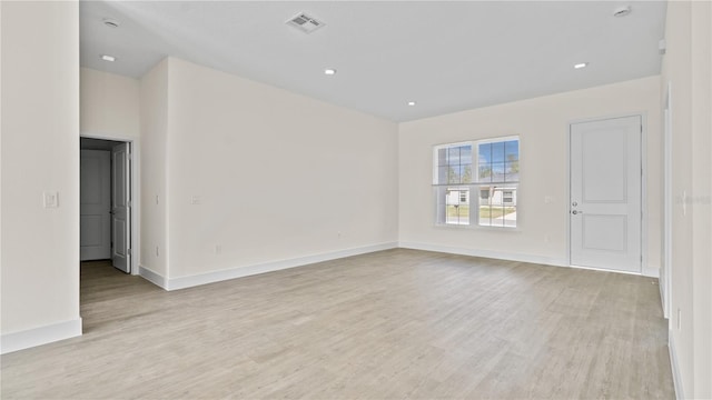 spare room featuring light wood-type flooring