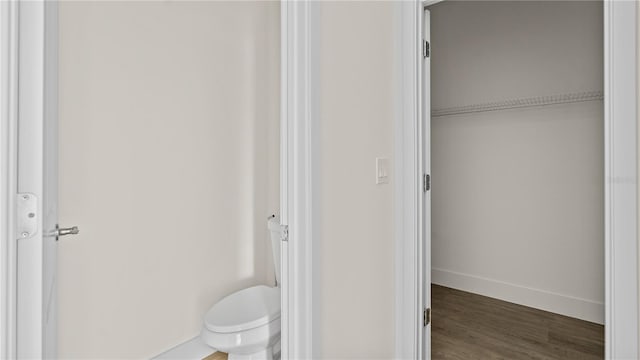 bathroom featuring hardwood / wood-style floors and toilet