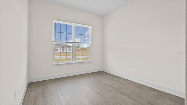 empty room with hardwood / wood-style floors