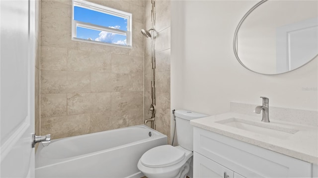 full bathroom featuring vanity, toilet, and tiled shower / bath