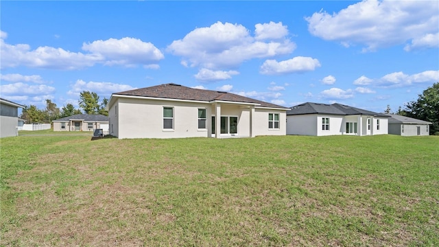 rear view of house with a yard