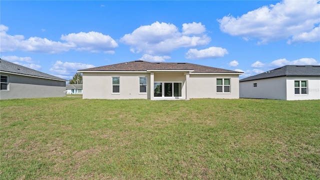 back of house with a lawn