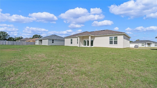 back of property featuring a lawn