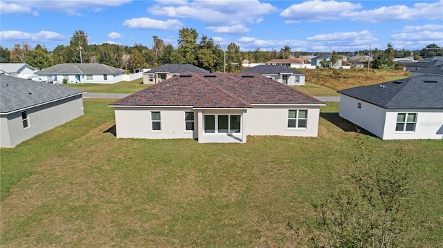 rear view of house with a lawn