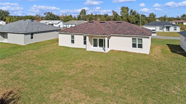 back of property featuring a yard