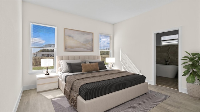 bedroom with light hardwood / wood-style floors and multiple windows