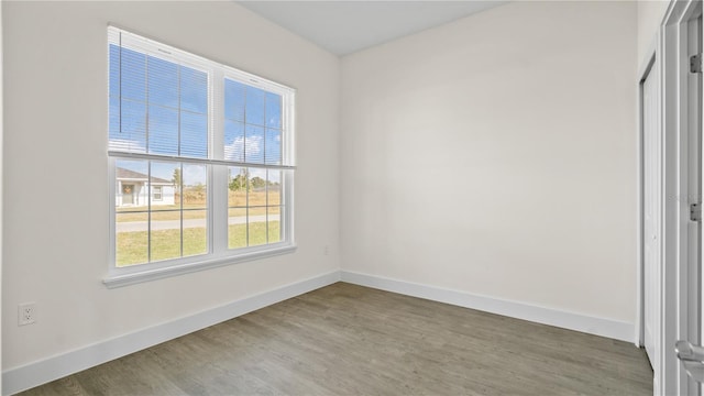 unfurnished room with hardwood / wood-style floors