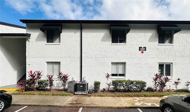 view of side of home with central AC