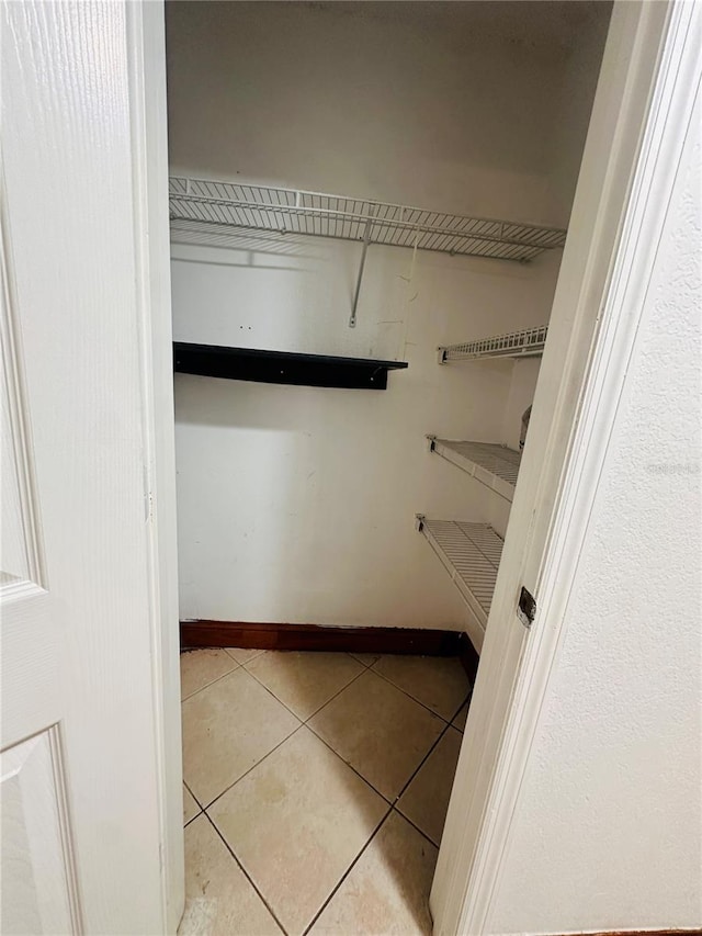 spacious closet with light tile patterned flooring