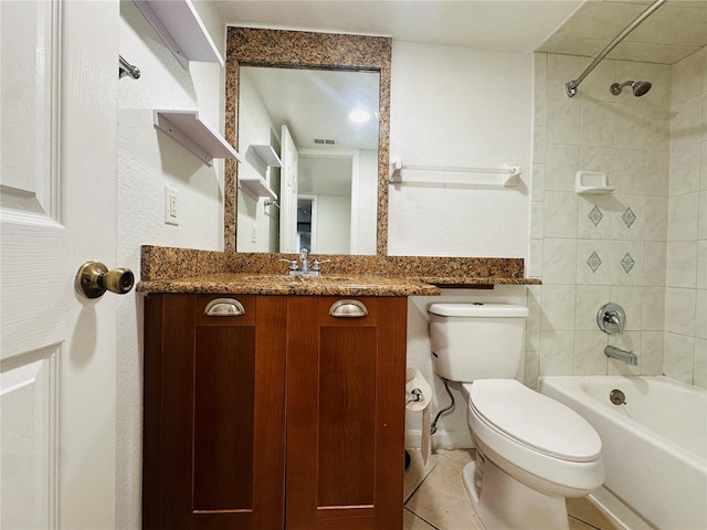 full bathroom with tile patterned flooring, tiled shower / bath, toilet, and vanity