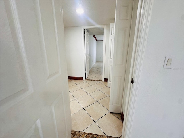 hall with light tile patterned floors