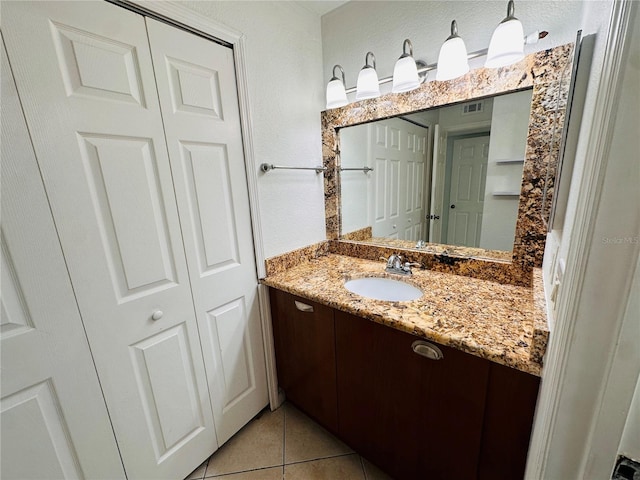 bathroom featuring tile patterned flooring and vanity