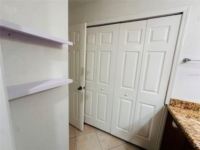 interior space with vanity and tile patterned floors