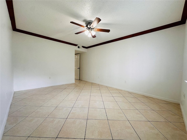 tiled empty room featuring a textured ceiling, ceiling fan, and crown molding