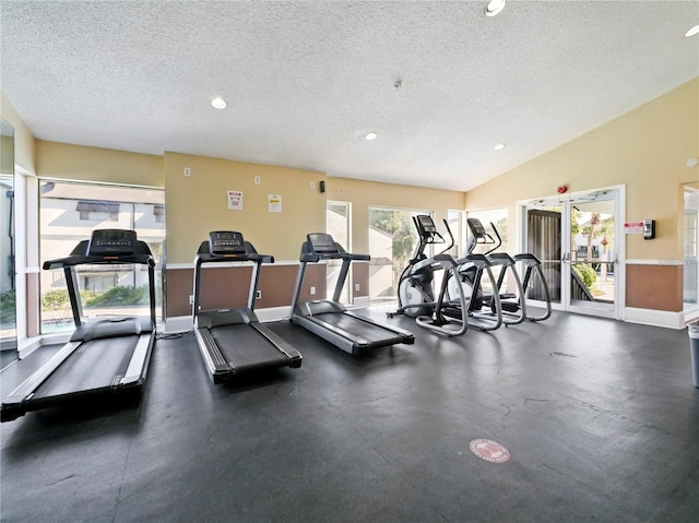 gym featuring french doors, a wealth of natural light, and a textured ceiling