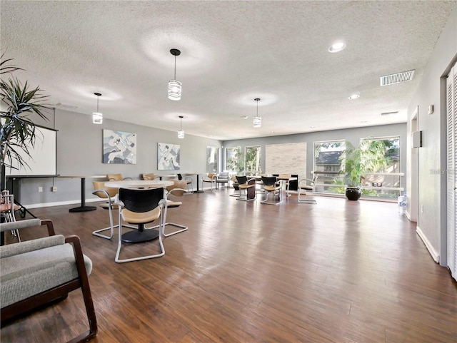 living room with dark hardwood / wood-style flooring and a textured ceiling