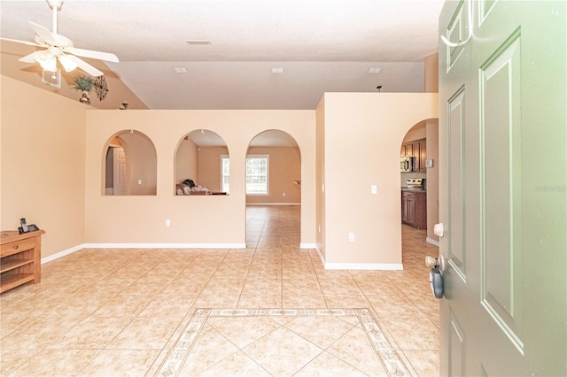 unfurnished room featuring light tile patterned flooring, ceiling fan, and lofted ceiling