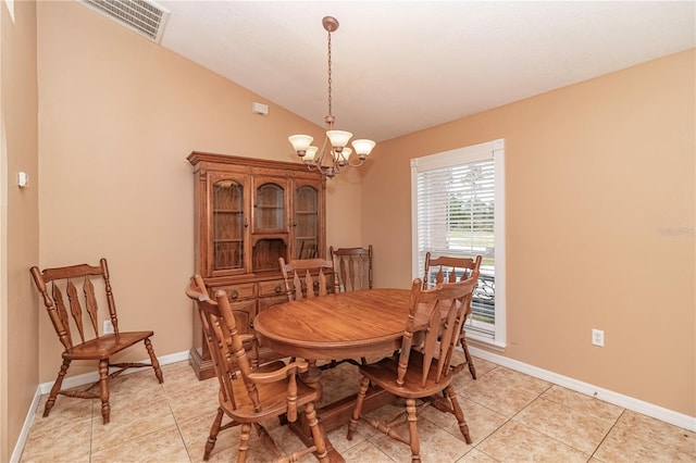 tiled dining area with vaulted ceiling and a notable chandelier