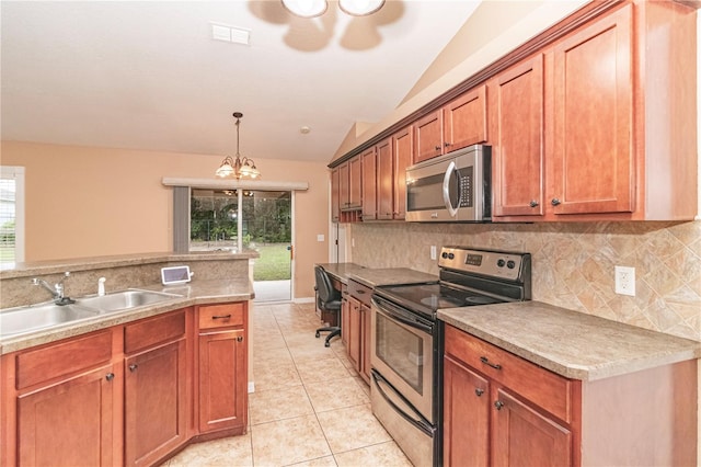 kitchen featuring stainless steel appliances, sink, vaulted ceiling, and plenty of natural light