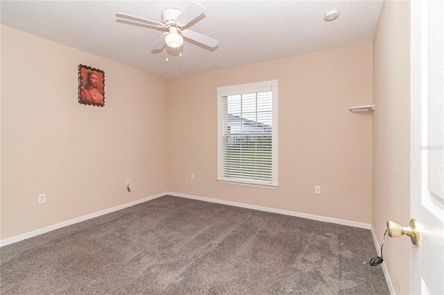 empty room with a textured ceiling, carpet floors, and ceiling fan