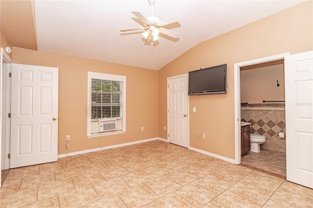 unfurnished bedroom featuring light tile patterned flooring, ceiling fan, connected bathroom, and tile walls