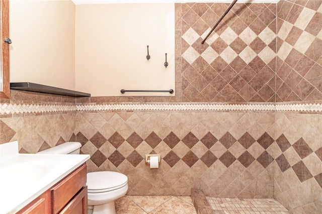 bathroom with toilet, walk in shower, tile patterned floors, and vanity