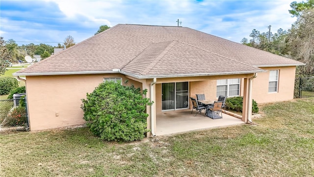 back of house with a patio area and a yard